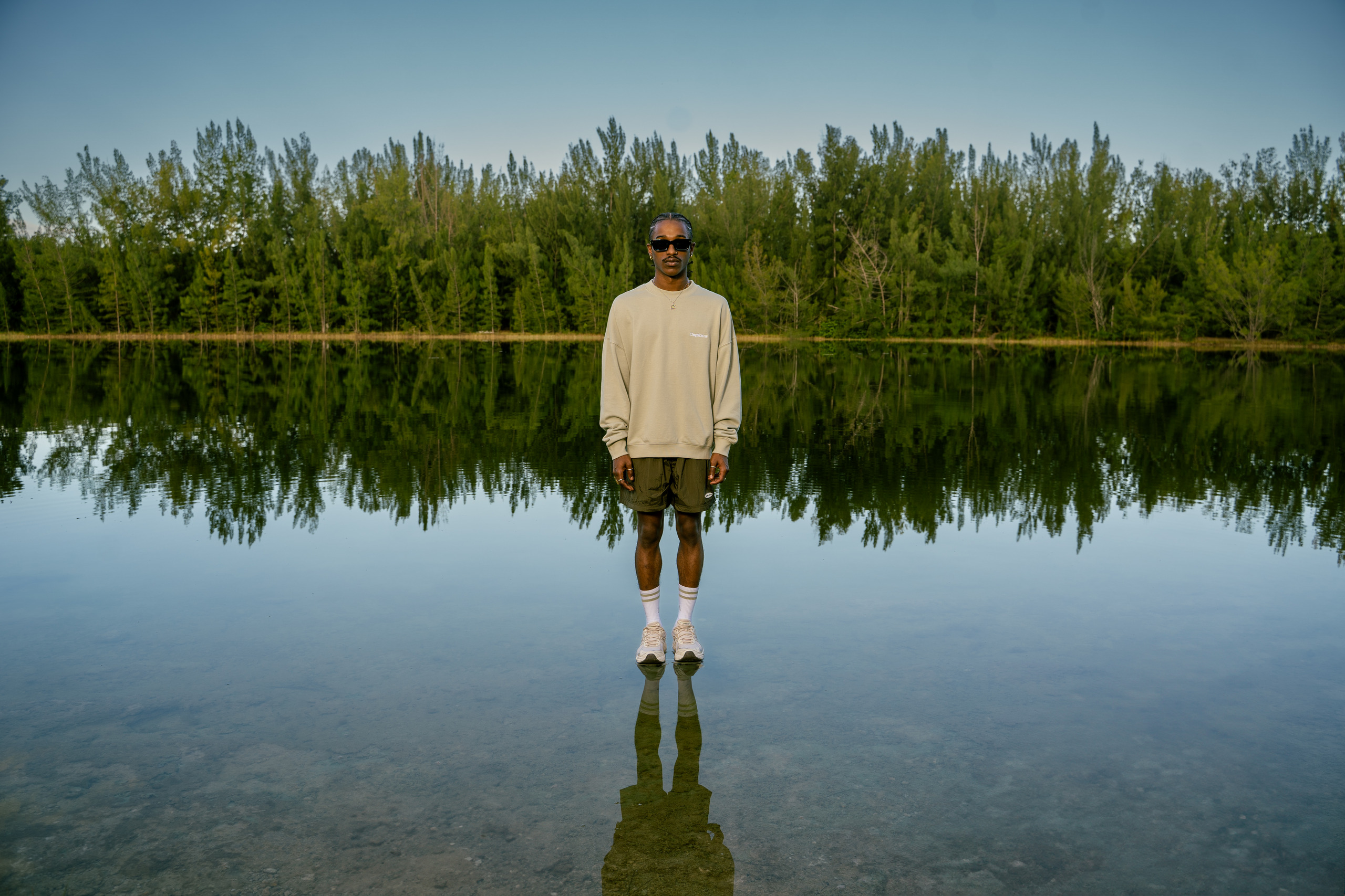 DSPLACE Glasslake campaign featuring a model reflected on a lake